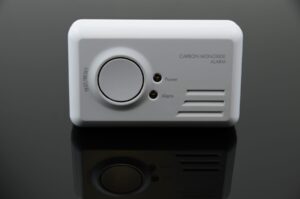 Carbon monoxide alarm on black background.