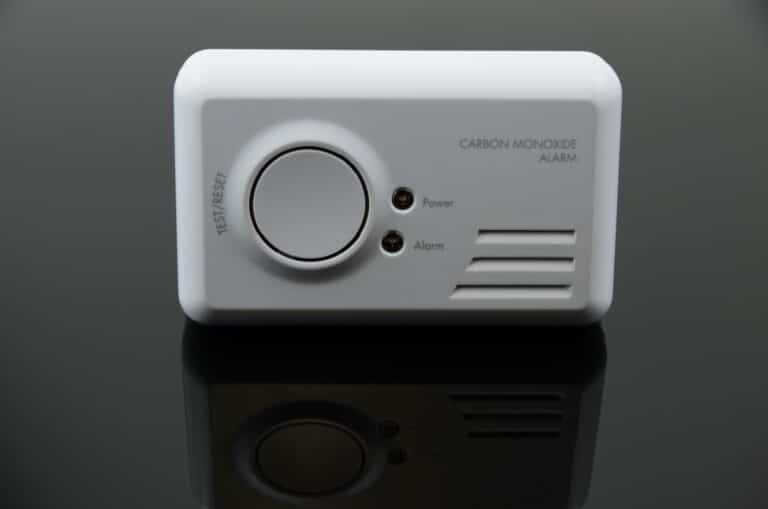 Carbon monoxide alarm on black background.