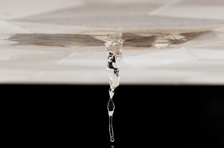 image of water dripping through crack in ceiling