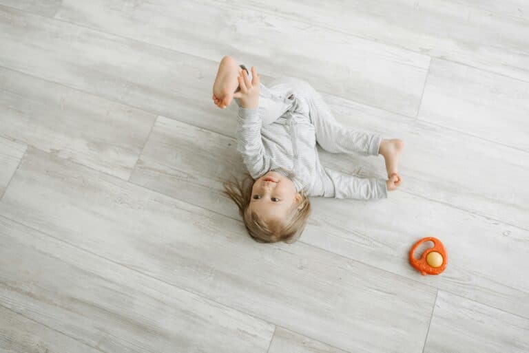 baby on wooden floor